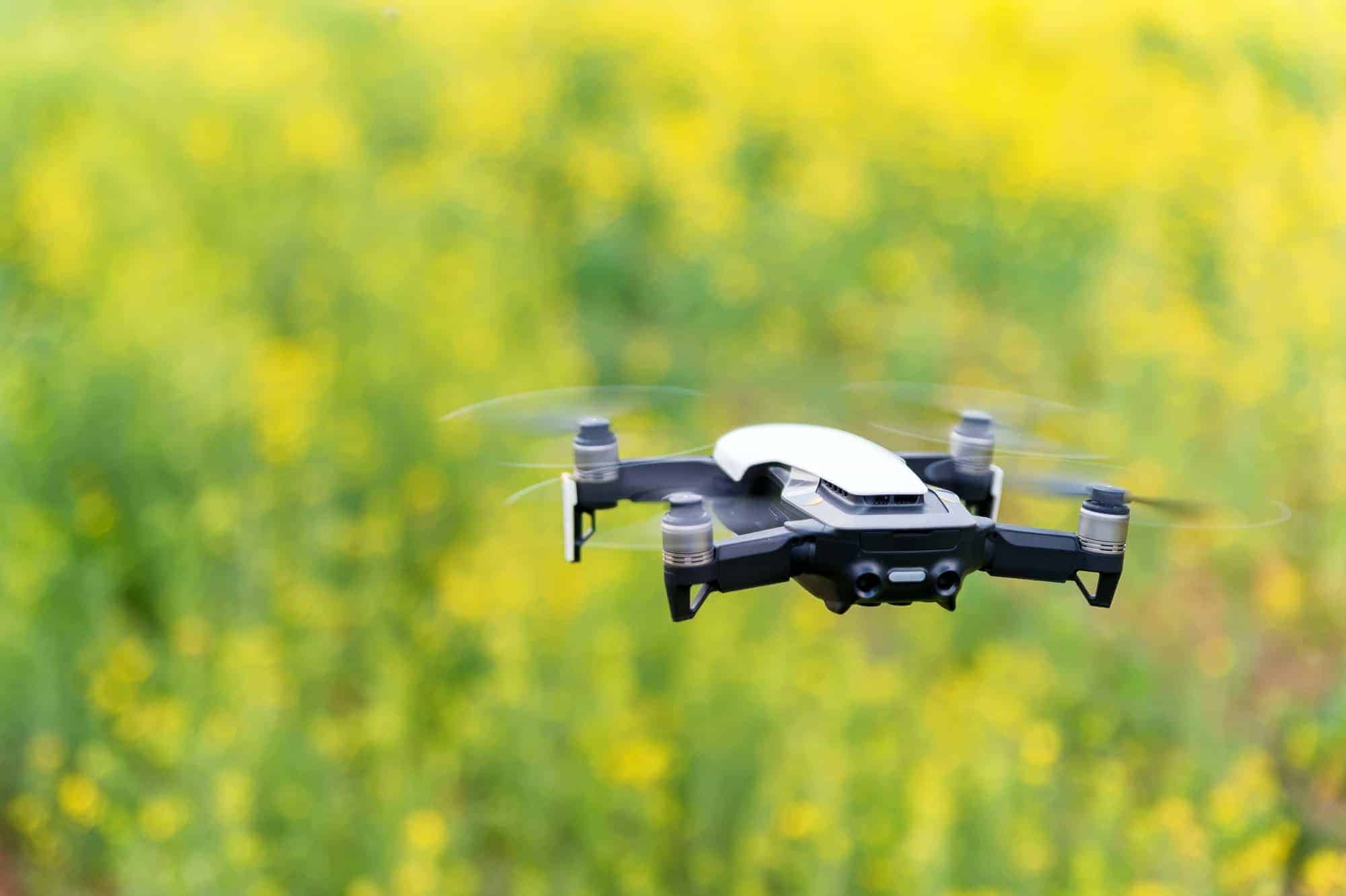 Modern dark and red drone in the air in mountains close